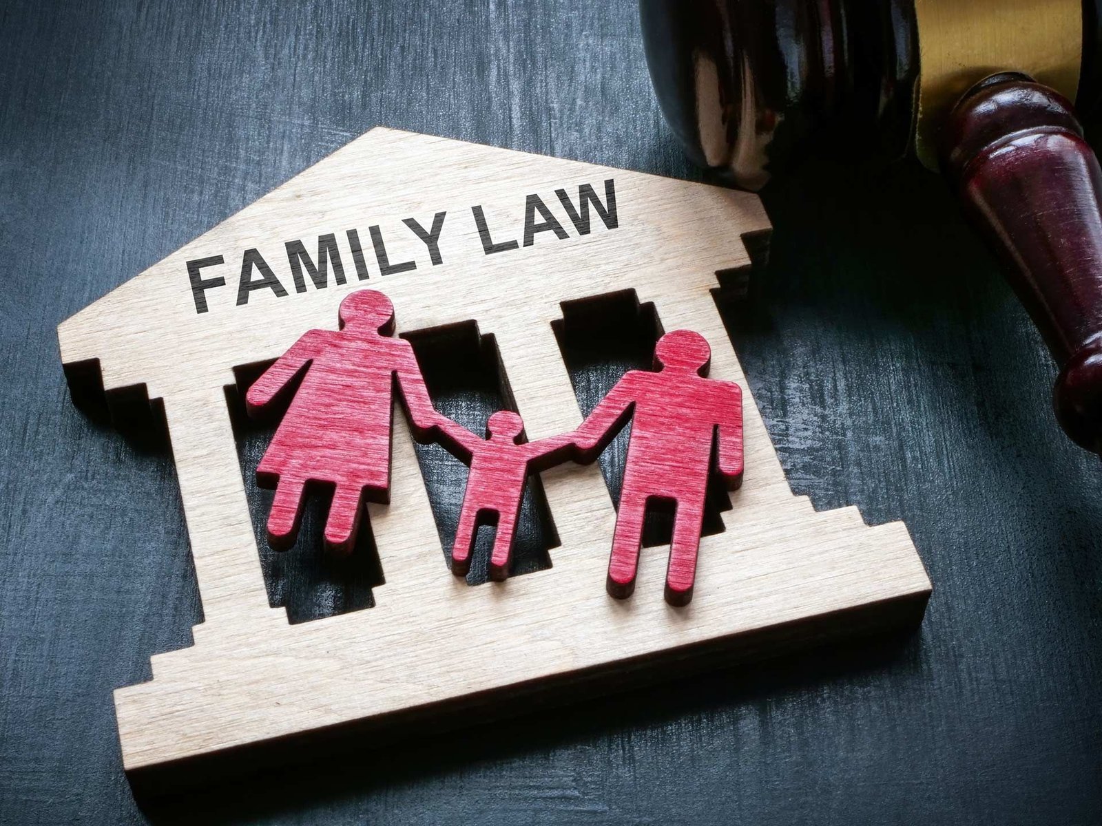 A wooden model of a family law building with a judge 's gavel.